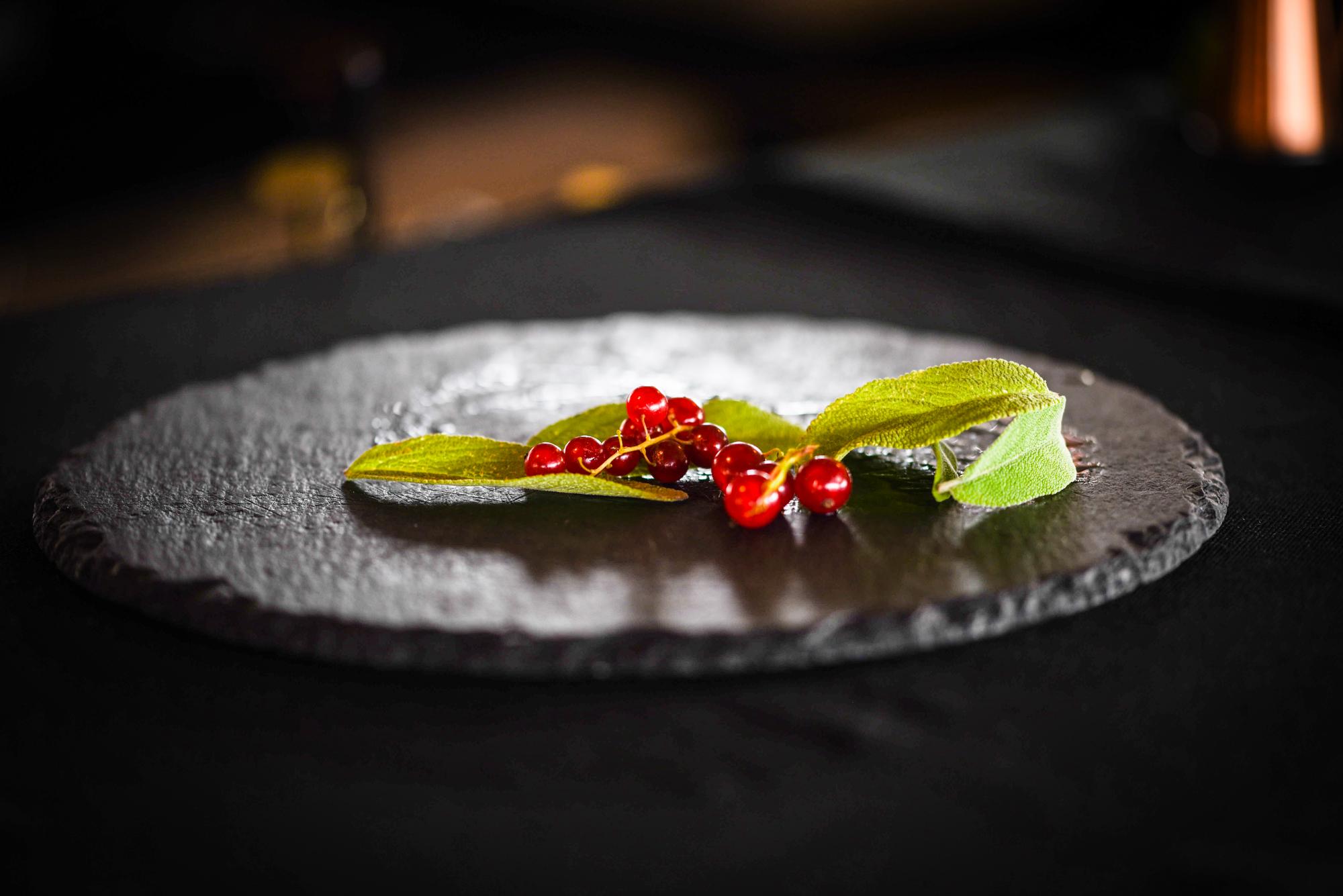 Plated signature dish on dark table